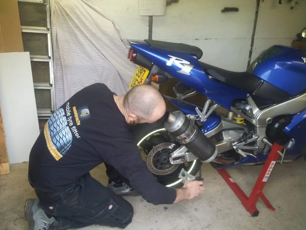 Mototyres 2 u fitting replacement new motorcycle tyres using motorbike stand. Wheel removal.