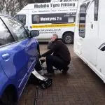 Mototyres 2 u Mobile Tyre fitting Lincolnshire Holbeach Tyres Lee Fitting Tyres On Drive between car and caravan